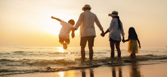 Happy,Asian,Family,Jumping,Together,On,The,Beach,In,Holiday.